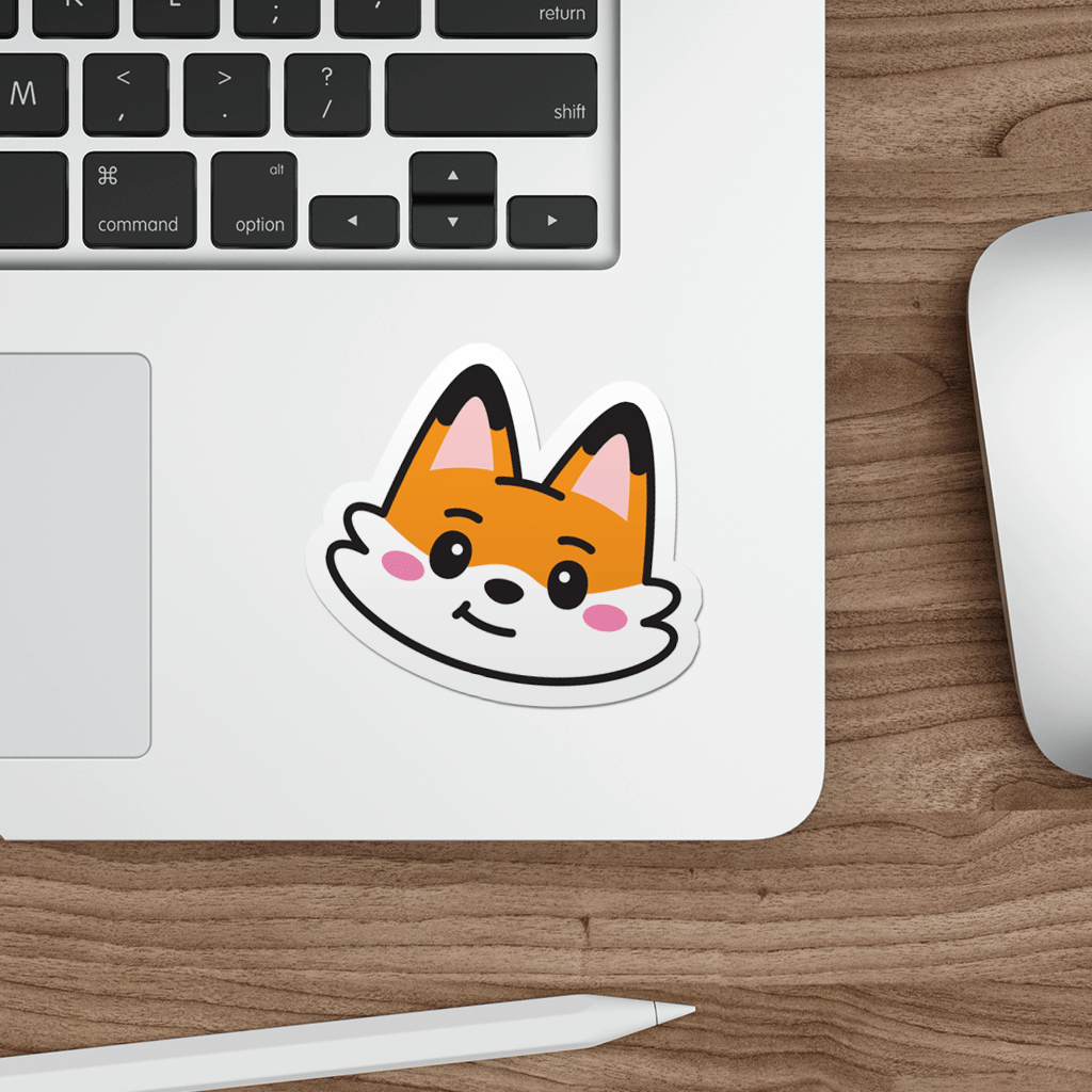 Laptop with a sticker of a cute cartoon fox face on a wooden desk.