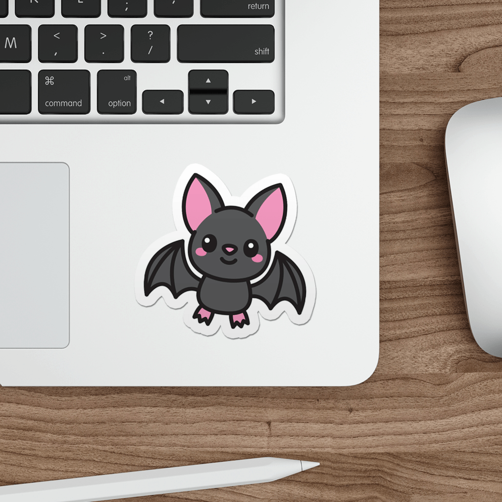 Laptop with a cute bat sticker on a wooden desk