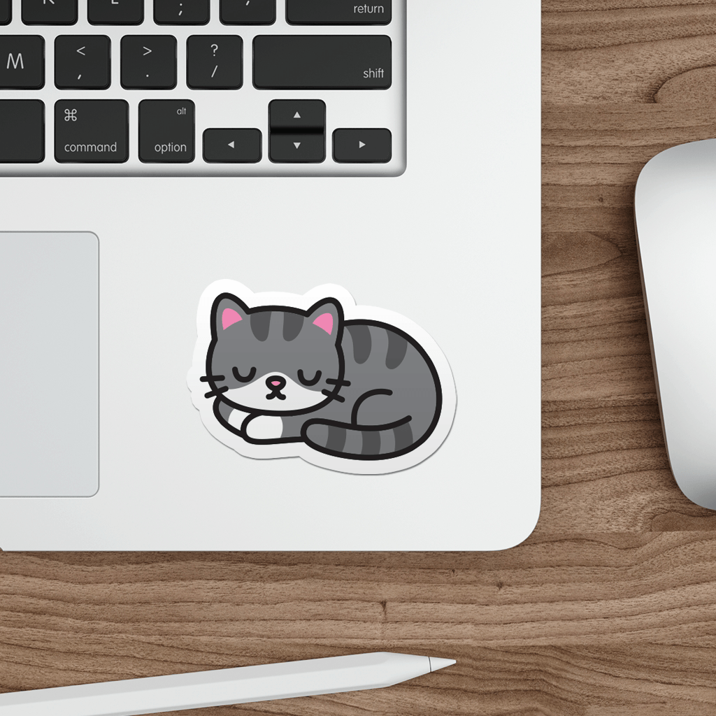 Laptop with a sticker of a cute sleeping cat on a wooden desk.