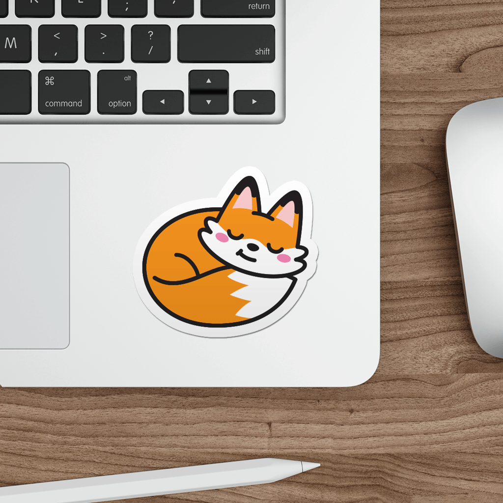 Laptop with a sticker of a cartoon fox on a wooden desk