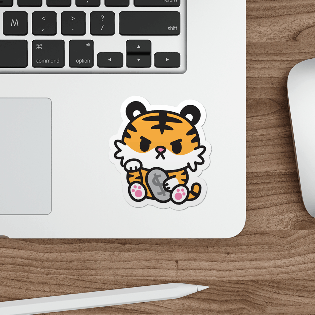 Laptop with a sticker of a cartoon tiger on a wooden desk.