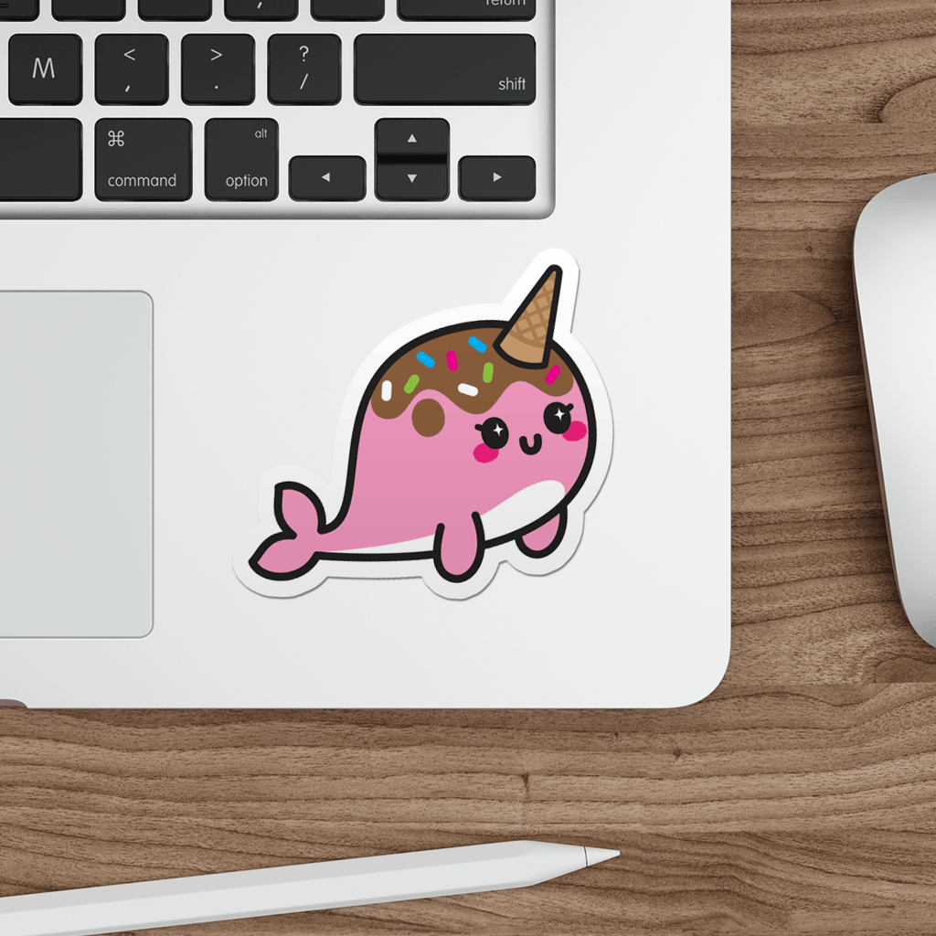 Laptop with a kawaii narwhal sticker on a wooden desk