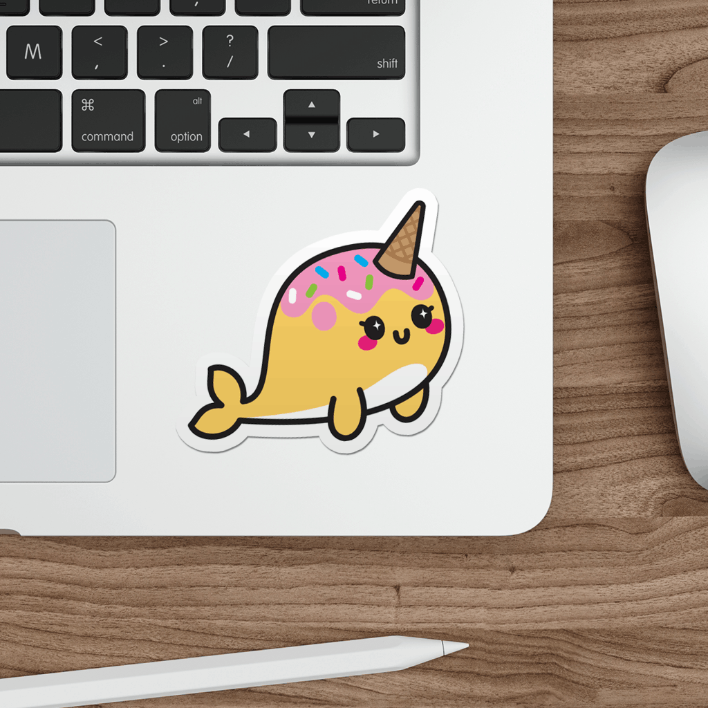 Laptop with a kawaii narwhal sticker on a wooden desk