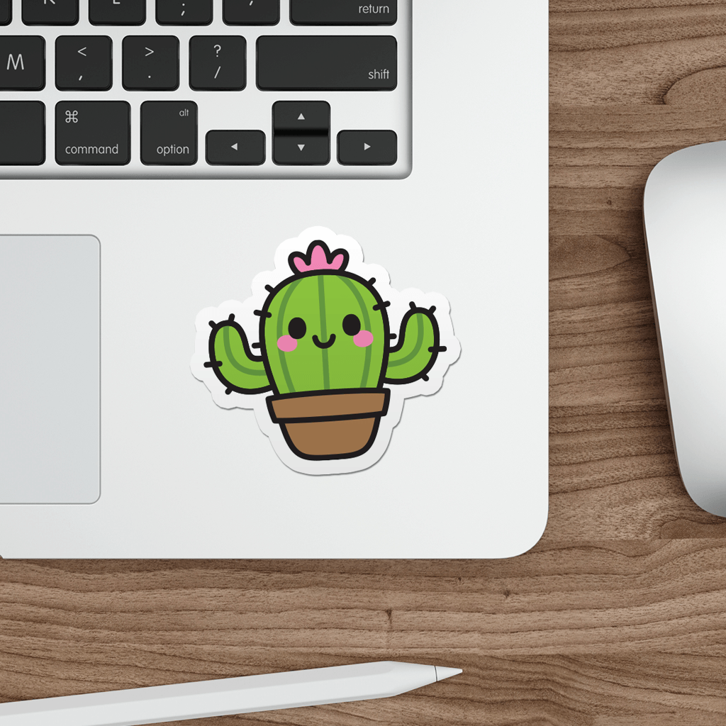 Laptop with a die-cut, vinyl sticker of a kawaii cactus on a wooden desk.