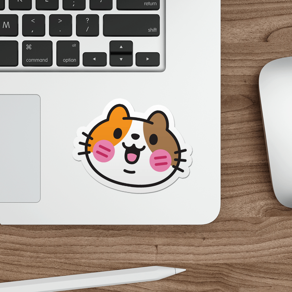 Laptop with a sticker of a kawaii  calico cat face on a wooden desk.