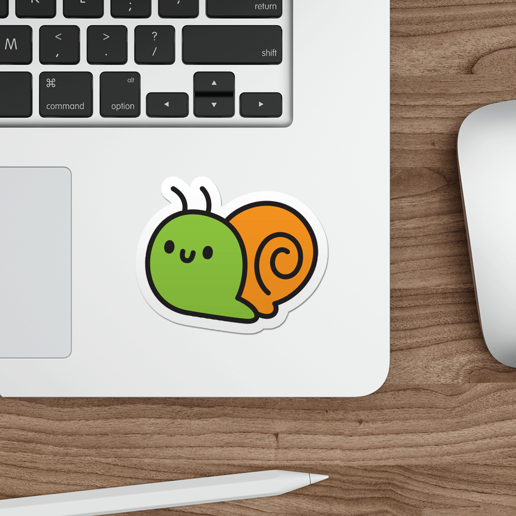 Laptop with a cartoon snail sticker on a wooden desk