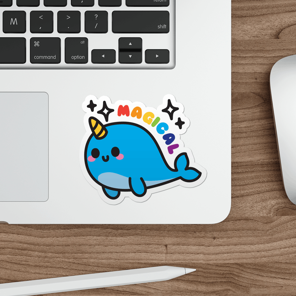 Laptop with a kawaii narwhal sticker on a wooden desk
